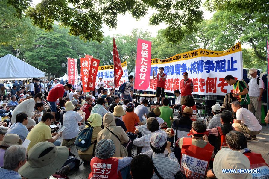 People attend a protest near the Peace Momorial Park in Hiroshima, Japan, on Aug. 6, 2016. 