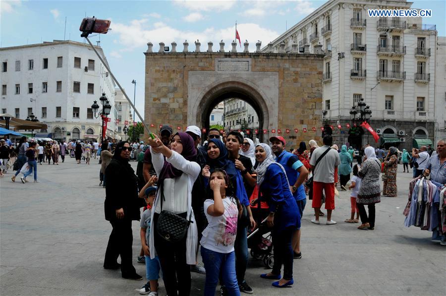 Tourists pose for selfies in the old city of Tunis, capital of Tunisia, on Aug. 6, 2016. 