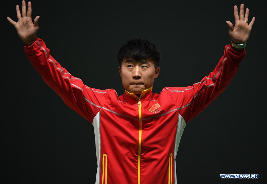 Bronze medalist China's Li Yuehong attends the awarding ceremony for the men's 25m rapid fire pistol final of Shooting at the 2016 Rio Olympic Games in Rio de Janeiro, Brazil, on Aug. 13, 2016.