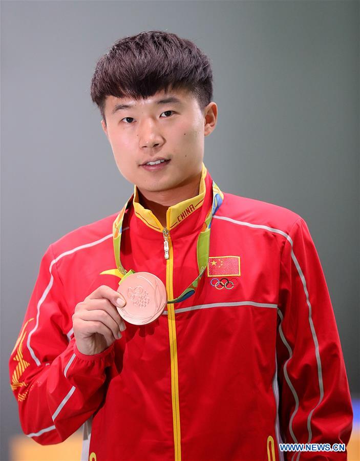 Bronze medalist China's Li Yuehong attends the awarding ceremony for the men's 25m rapid fire pistol final of Shooting at the 2016 Rio Olympic Games in Rio de Janeiro, Brazil, on Aug. 13, 2016.
