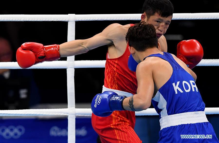 China's Zhang Jiawei (L) competes with South Korea's Ham Sangmyeong during the men's bantam(56KG) preliminary of boxing at the 2016 Rio Olympic Games in Rio de Janeiro, Brazil, on Aug. 14, 2016.