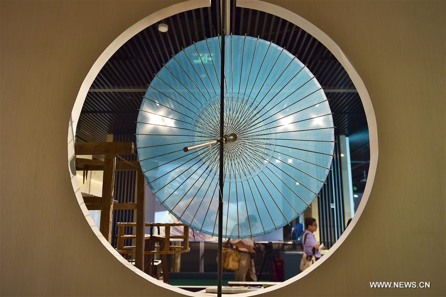 Traditional materials and tools used for making silk umbrellas are displayed during a West Lake silk umbrella show in Hangzhou, capital of east China's Zhejiang Province, Aug. 26, 2016. 