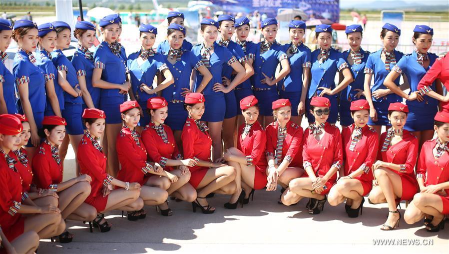 Models pose for photo during the 5th Shenyang Faku International Flight Conference in Shenyang, capital city of northeast China's Liaoning Province, Aug. 27, 2016.