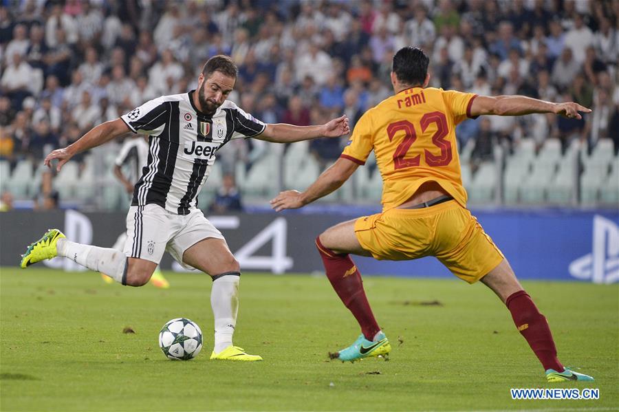 Gonzalo Higuain (L) of Juventus vies with Adil Rami of Sevilla during the UEFA Champions League soccer match in Turin, Italy, Sept. 14, 2016.
