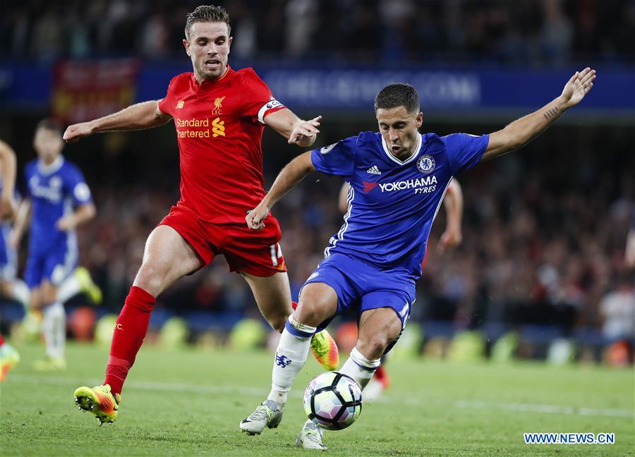 Eden Hazard (R) of Chelsea vies for the ball with Jordan Henderson of Liverpool during their English Premier League match in London, Britain, on Sept. 16, 2016. Liverpool won 2-1. 