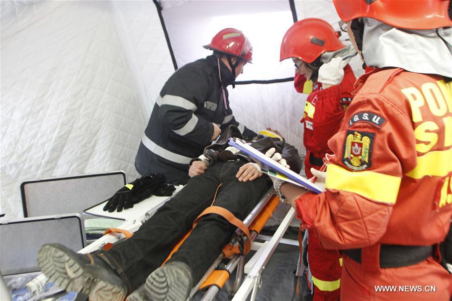 Firefighters and medical emergency staff take part in a rescue operation during an earthquake exercise held in Bucharest, Romania, Nov. 1, 2016.