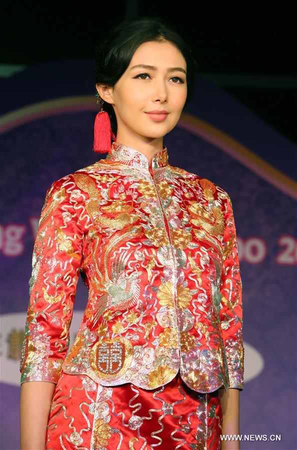 Models present Chinese traditional wedding dresses at Hong Kong Wedding Expo 2016 in Hong Kong, south China, Nov. 5, 2016. 