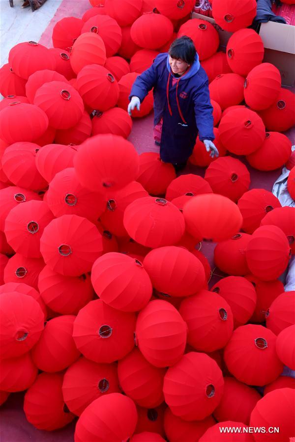 A villager walks among red lanterns in Beileng Township of Wenxian County, central China's Henan Province, Jan. 12, 2017. Villagers need to keep up with the lantern orders to meet the Spring Festival market demand. The Spring Festival falls on Jan. 28 this year. (Xinhua/Xu Hongxing) 