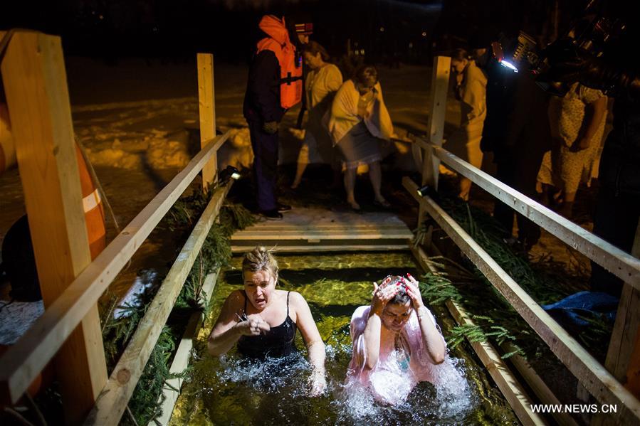 People take a dip in icy water during the Orthodox Epiphany celebrations in Moscow, Russia, on Jan. 18, 2017
