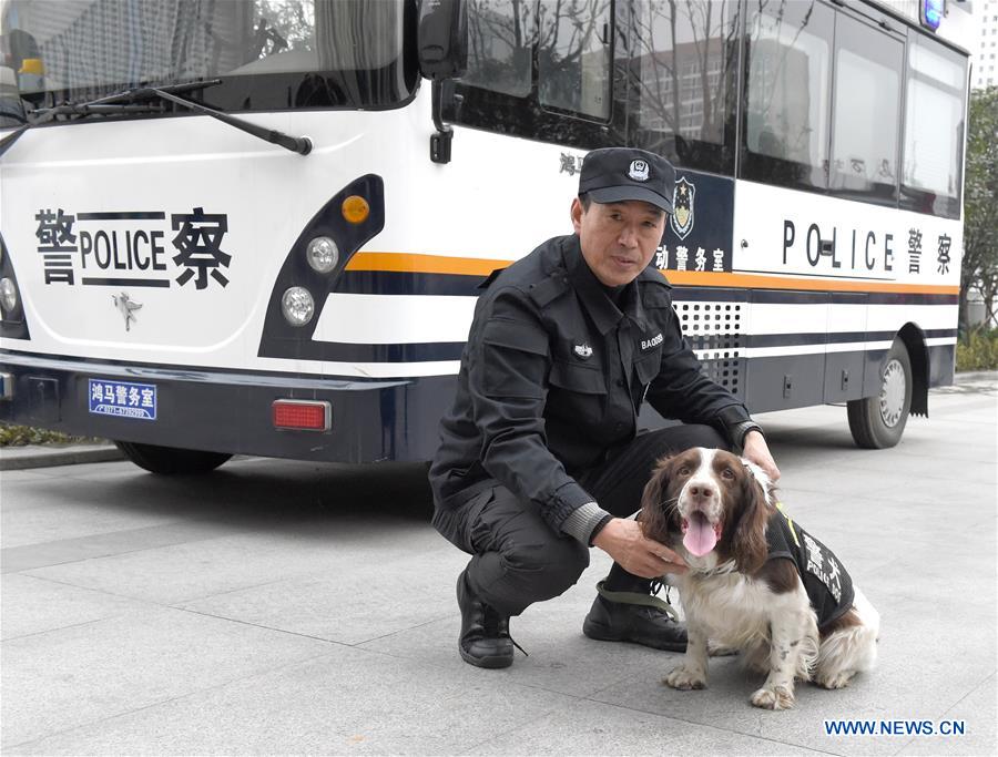 Trainer Yang Naiwen poses for a photo with police dog Tiehu at the square of Hefei Railway Station in Hefei, capital of east China's Anhui Province, Jan. 24, 2017. Many police dogs are on duty during China's Spring Festival travel rush between Jan. 13 and Feb. 21. This is the 7th time for Tiehu, an 8-year-old sniffer dog, to serve the travel rush around the Spring Festival, which falls on Jan. 28 this year. (Xinhua/Guo Chen) 