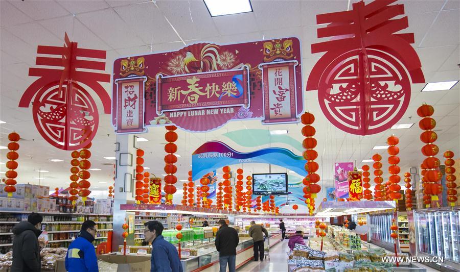 People shop at a Chinese supermarket with decorations celebrating the Chinese Lunar New Year in Toronto, Canada, Feb. 2, 2017.