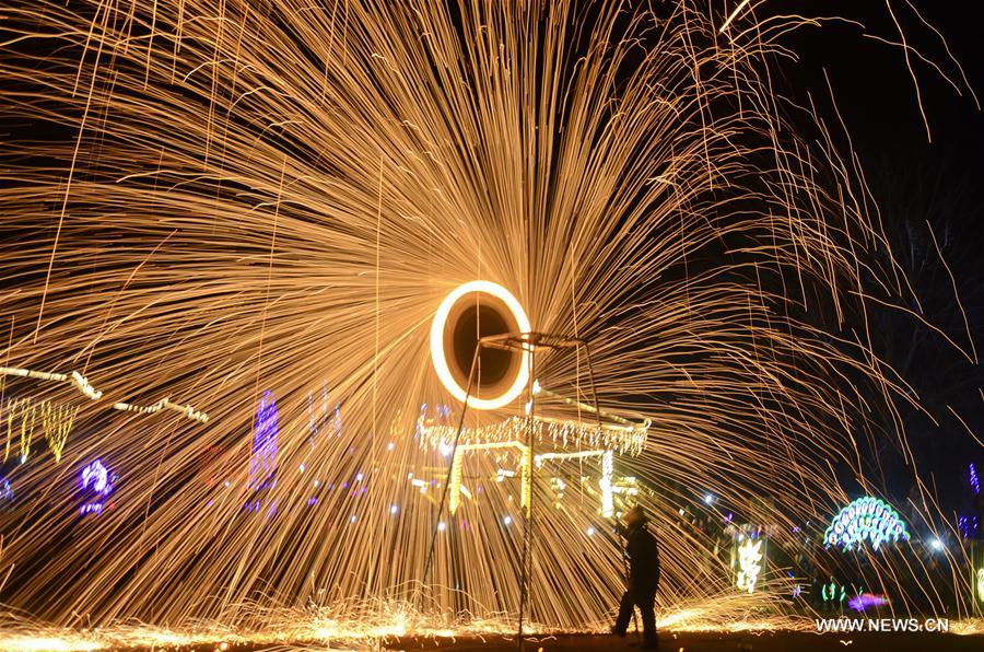 Sparks pour down as performers spray burning hot iron water to simulate display of fireworks at Neihuang County, central China's Henan Province, Feb. 1, 2017. (Xinhua/Li Gang) 