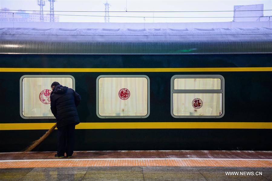 A cleaner sweeps snow on a platform at the Hohhot Railway Station in Hohhot, capital of north China's Inner Mongolia Autonomous Region, Feb. 7, 2017. Hohhot greeted a snow on Tuesday morning