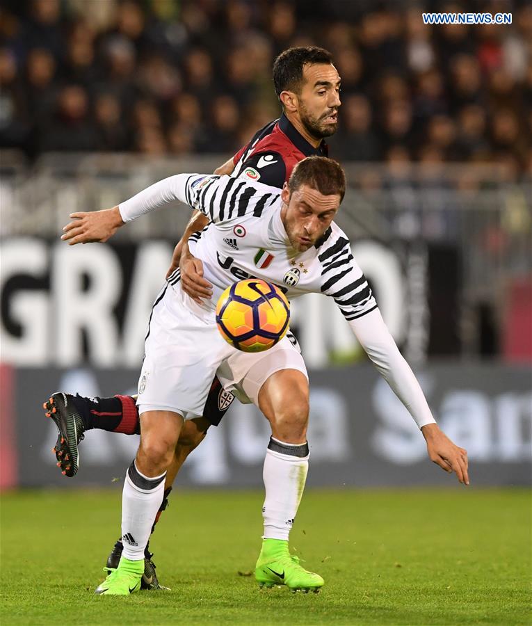 Juventus' Claudio Marchisio(Front) vies with Cagliari's Marco Sau during the Serie A soccer match between Juventus and Cagliari, in Cagliari, Italy, Feb. 12, 2017.