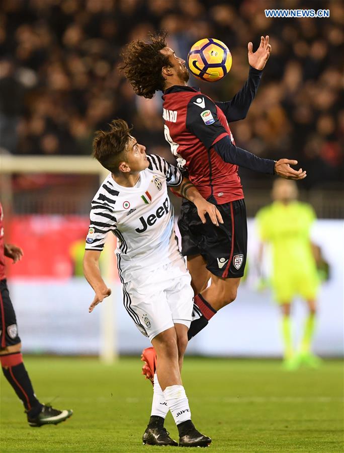 Cagliari's Davide Di Gennaro(R) vies with Juventus' Paulo Dybala during the Serie A soccer match between Juventus and Cagliari, in Cagliari, Italy, Feb. 12, 2017. 