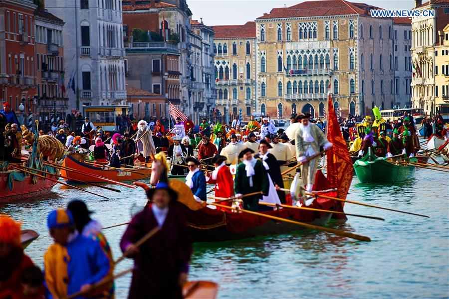 Rowers wearing costumes sail during the Water Parade event of the Venice Carnival in Venice, Italy, Feb. 12, 2017.