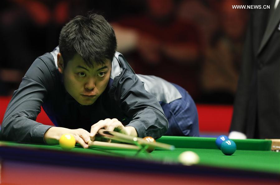 Liang Wenbo of China competes during the second round match against Michael White of Wales at Welsh Open 2017 in Cardiff, Wales, Britain on Feb. 15, 2017. 