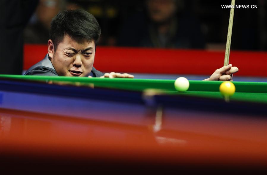Liang Wenbo of China competes during the second round match against Michael White of Wales at Welsh Open 2017 in Cardiff, Wales, Britain on Feb. 15, 2017.
