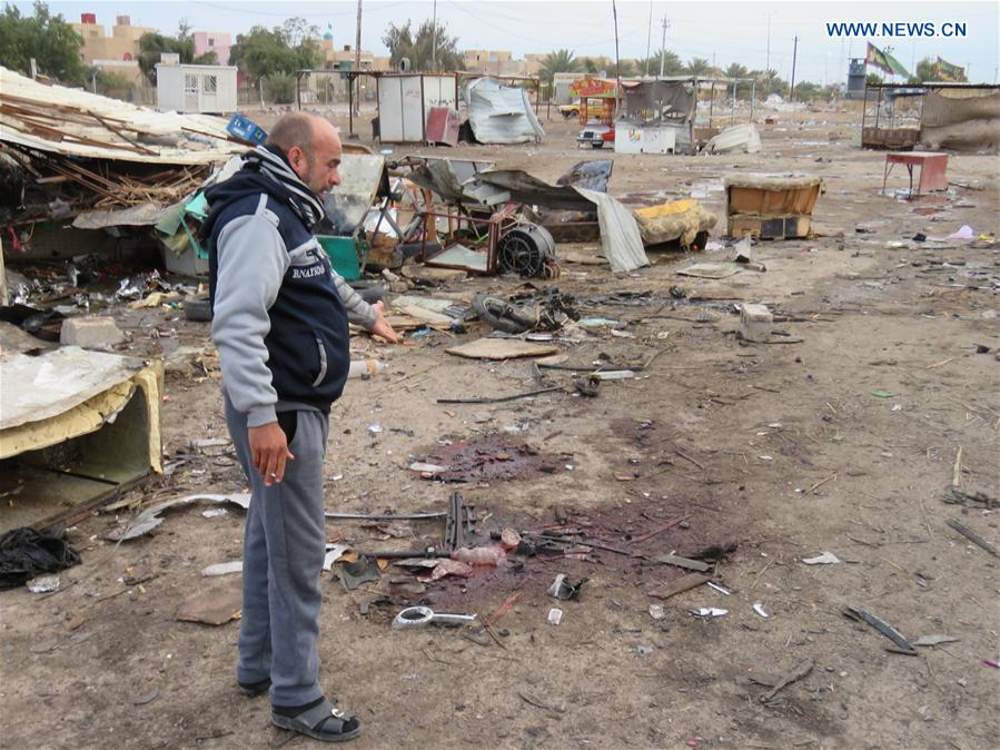 A man looks at the wreckage at the site of the bomb attack in Baghdad, Iraq, Feb. 16, 2017. 