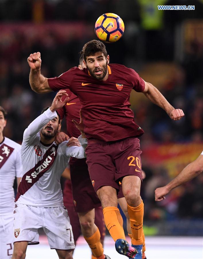 Roma's Federico Fazio (Top) vies for the ball during a Serie A soccer match between Roma and Torino in Rome, Italy, Feb. 19, 2017. 