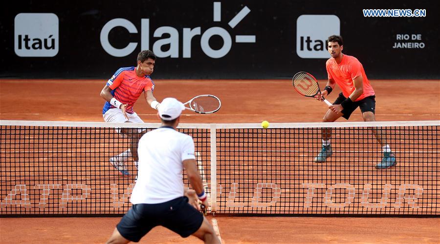 Thomaz Bellucci (above R) and Thiago Monteiro (above L) of Brazil compete during their 1st round doubles match against Juan Sebastian Cabal and Robert Farah of Colombia at the 2017 ATP Rio Open tennis tournament held at the Brazilian Jockey Club in Rio de Janeiro, Brazil, on Feb. 22, 2017.