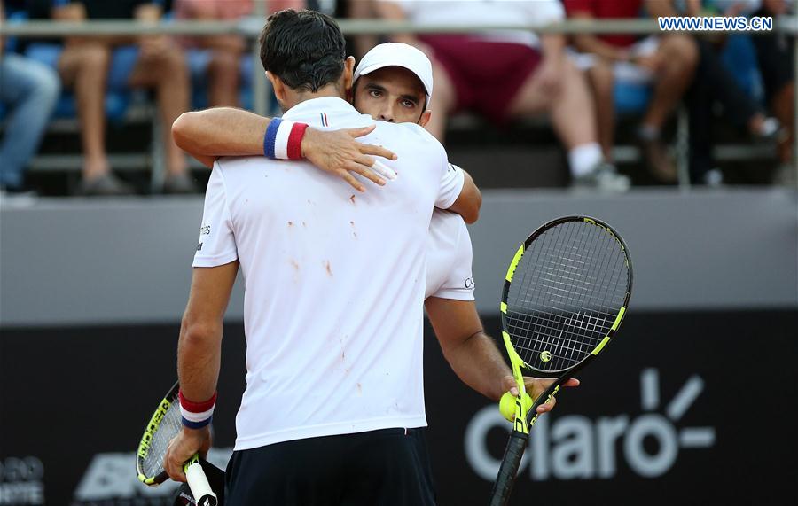 Juan Sebastian Cabal (back) hugs with Robert Farah of Colombia after winning their 1st round doubles match against Thomaz Bellucci and Thiago Monteiro of Brazil at the 2017 ATP Rio Open tennis tournament held at the Brazilian Jockey Club in Rio de Janeiro, Brazil, on Feb. 22, 2017.