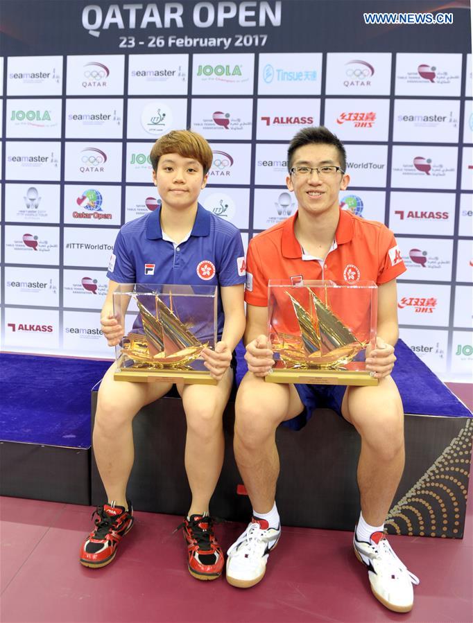 U21 Women's singles winner Doo Hoi Kem (L) and U21 Men's singles winner Lam Siu Hang of Hong Kong, China, pose with their trophies during the awarding ceremony for the U21 Men's and Women's singles event at the 2017 ITTF World Tour Platinum, Qatar Open in Doha, capital of Qatar, Feb. 22, 2017.
