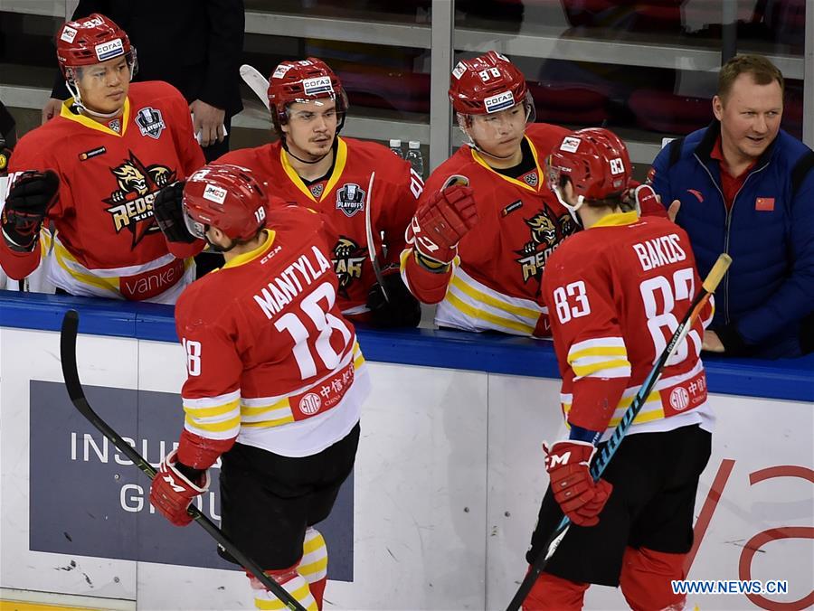 Zack Yuen (1st L, back) and Ying Rudi (2nd R, back) of Kunlun Red Star celebrate scoring with teammates during a playoff game between Kunlun Red Star of China and Metallurg Magnitogorsk of Russia at the Kontinental Hockey League (KHL) in Beijing, capital of China, Feb. 28, 2017. Kunlun Red Star won 3-1.