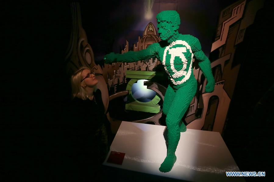 A visitor looks at the work 'Green Lantern: Green' made of Lego bricks during the exhibition 'The Art of Brick: DC Super Heroes' by artist Nathan Sawaya, on the South Bank in London, Britain, on Feb. 28, 2017. The exhibition featured sculptures based on the DC Comics universe and used more than 2 million Lego bricks. 
