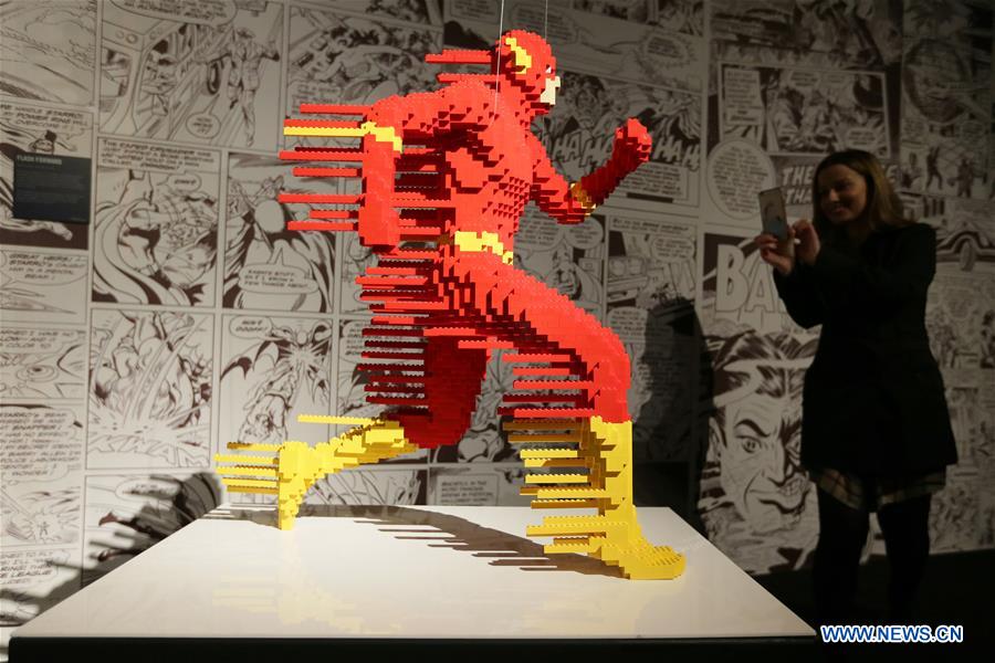 A visitor takes a photo of the work 'Flash Forward' made of Lego bricks during the exhibition 'The Art of Brick: DC Super Heroes' by artist Nathan Sawaya, on the South Bank in London, Britain, on Feb. 28, 2017. The exhibition featured sculptures based on the DC Comics universe and used more than 2 million Lego bricks.