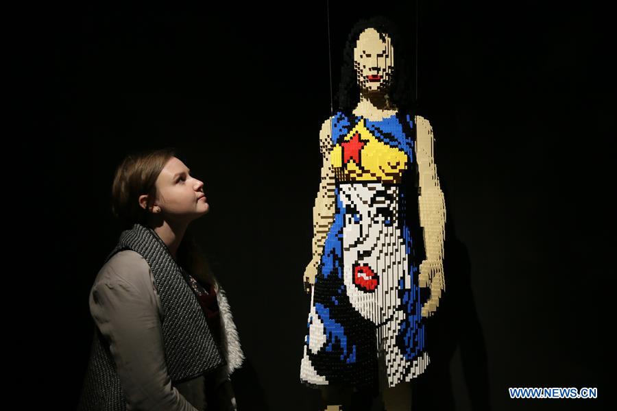 A visitor looks at the work 'Amazon Warrior' made of Lego bricks during the exhibition 'The Art of Brick: DC Super Heroes' by artist Nathan Sawaya, on the South Bank in London, Britain, on Feb. 28, 2017. The exhibition featured sculptures based on the DC Comics universe and used more than 2 million Lego bricks. 