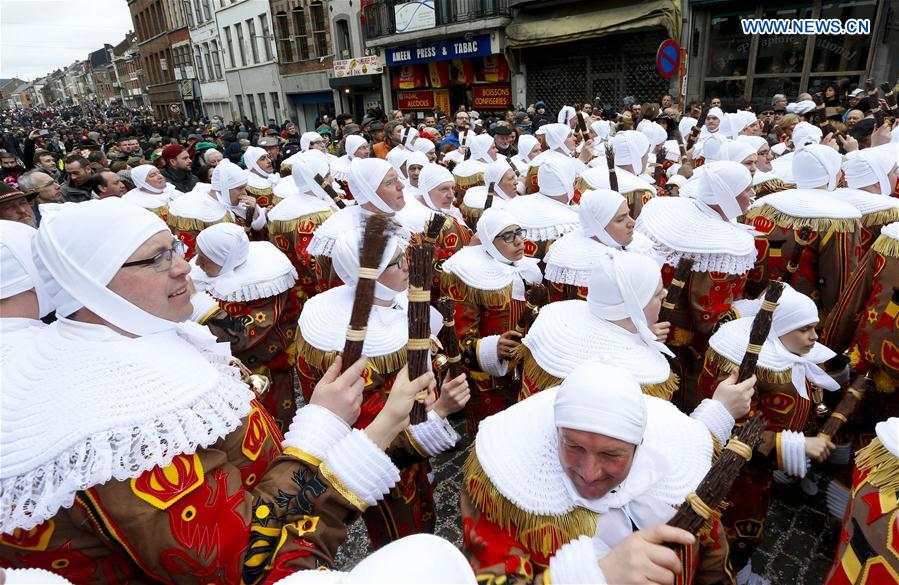Local residents wearing costumes of 'Gilles' attend the parade of Mardi Gras (Shrove Tuesday), the last day of Carnival in Binche, some 60 km south to Brussels, capital of Belgium, Feb. 28, 2017. 