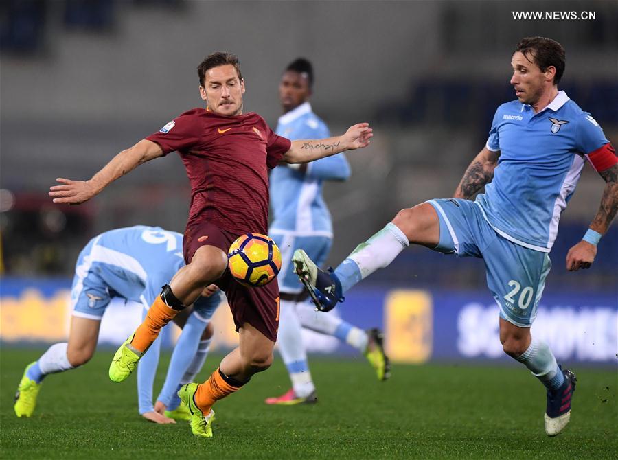 Roma's Francesco Totti (L) competes with Lazio's Lucas Biglia during the Italian Cup first leg semifinal football match in Rome, Italy, March 1, 2017. 