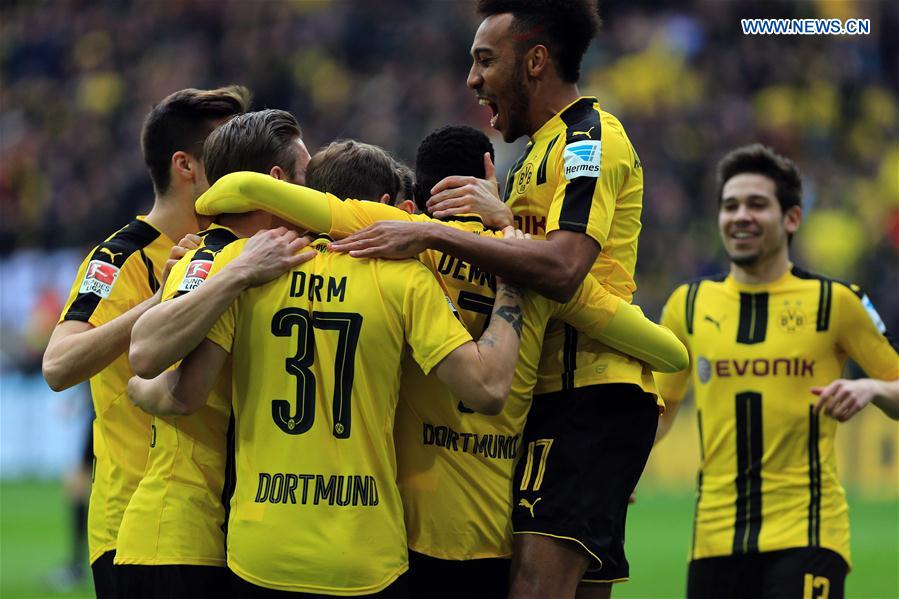 Team members of Borussia Dortmund celebrate after scoring the openning goal during the Bundesliga match against Bayer 04 Leverkusen at Signal Iduna Park in Dortmund, Germany, March 4, 2017. 