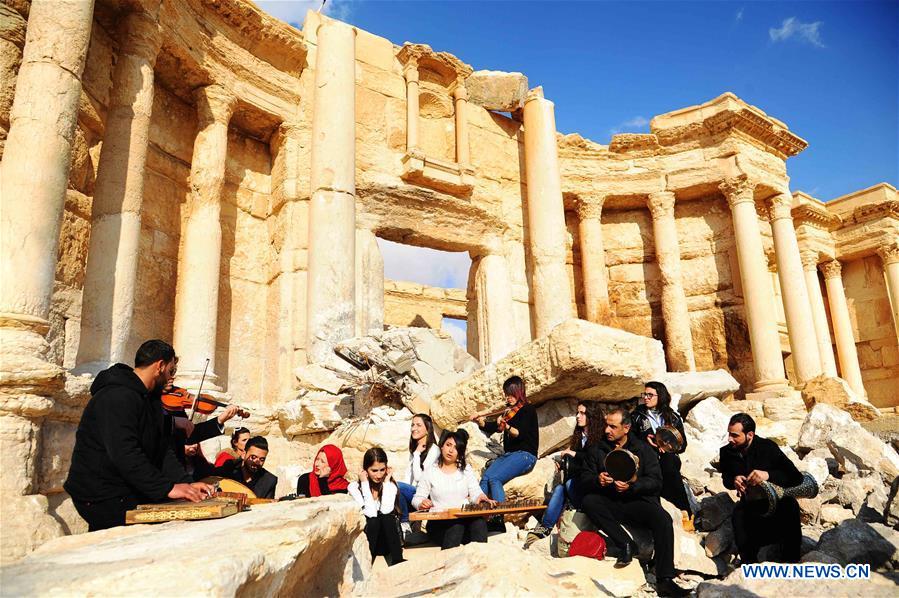 A musical band plays amid the rubble of the ruined Roman Theater in the ancient city of Palmyra, central Syria, on March 4, 2017. The Syrian army announced in a statement that the Syrian forces captured the ancient city of Palmyra in central Syria on Thursday after battles with the Islamic State (IS) group.