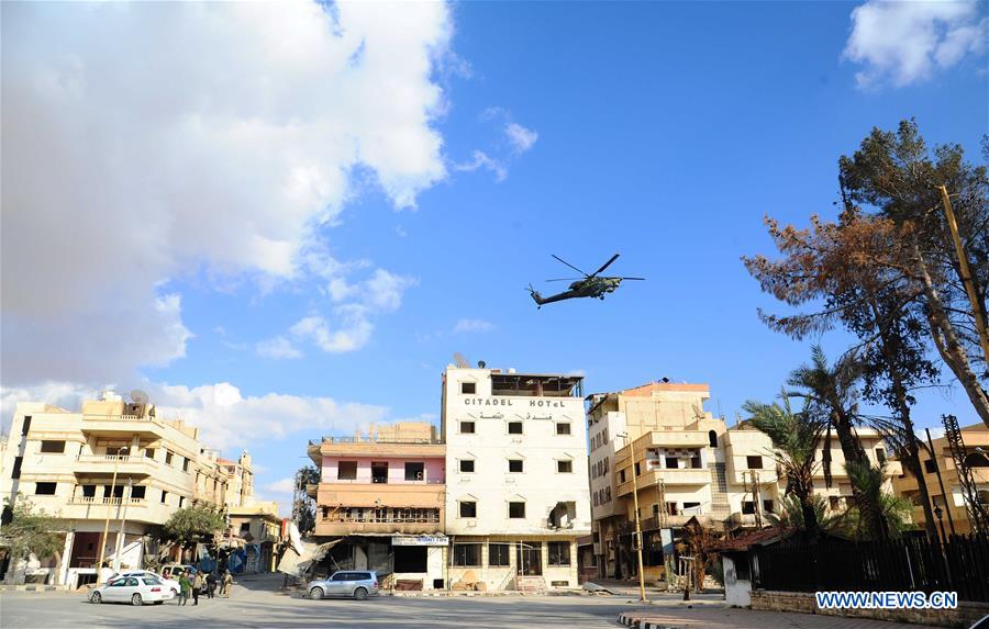 A Russian helicopter hovers over the residential part of the ancient city of Palmyra, central Syria, on March 4, 2017. The Syrian army announced in a statement that the Syrian forces captured the ancient city of Palmyra in central Syria on Thursday after battles with the Islamic State (IS) group.