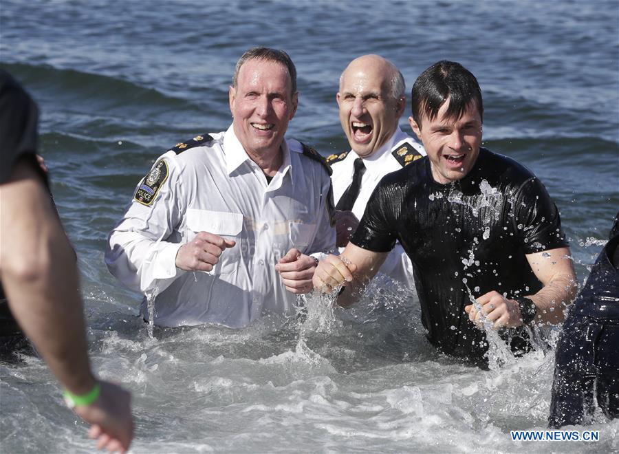 Police officers participate in Polar Plunge to raise money for Special Olympics at Kitsilano Beach in Vancouver, Canada, March 4, 2017. 