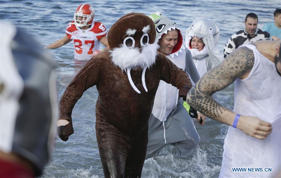 People participate in Polar Plunge to raise money for Special Olympics at Kitsilano Beach in Vancouver, Canada, March 4, 2017. 