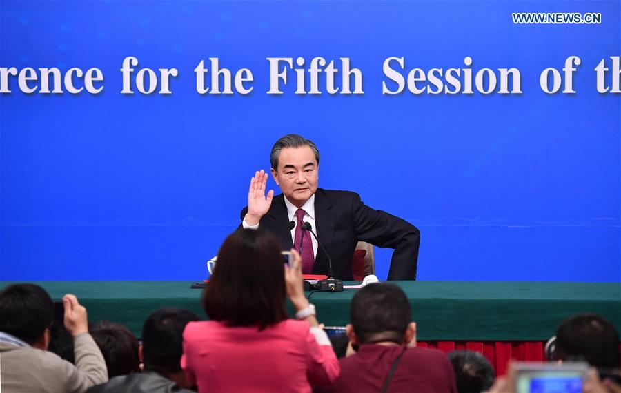 Chinese Foreign Minister Wang Yi waves to media at a press conference on China's foreign policy and foreign relations for the fifth session of the 12th National People's Congress in Beijing, capital of China, March 8, 2017.