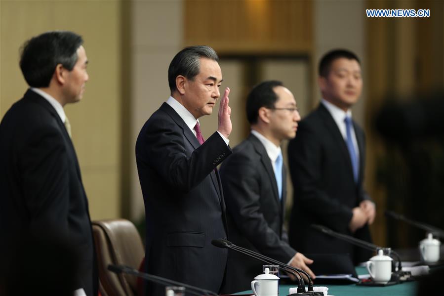 Chinese Foreign Minister Wang Yi (2nd L) waves to media at a press conference on China's foreign policy and foreign relations for the fifth session of the 12th National People's Congress in Beijing, capital of China, March 8, 2017. 