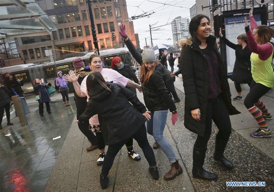 Women participate in a flash mob dance to celebrate the International Women's Day in Vancouver, Canada, March 7, 2017. 