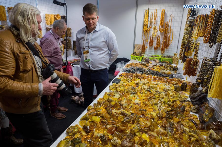 Customers select amber products on the 'Amber Trip' exhibition in Vilnius, Lithuania, on March 8, 2017.