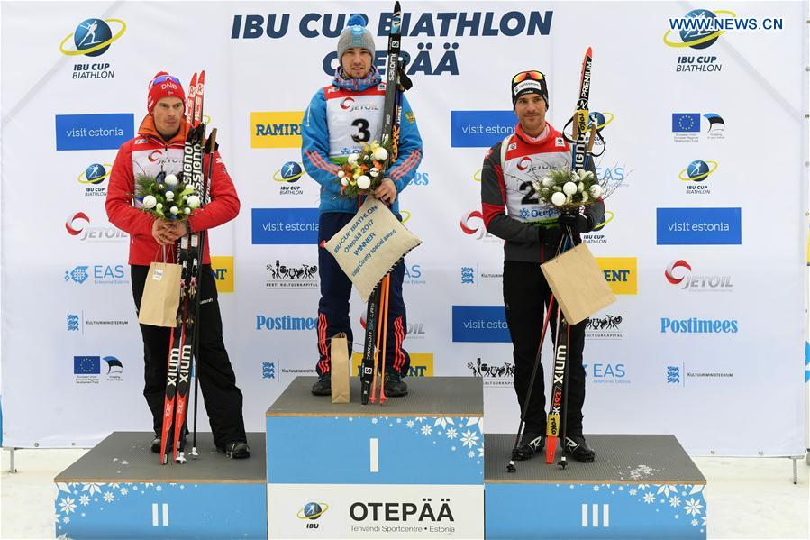 Alexandr Loginov(C) of Russia poses with Norwegian Henrik L' Abee-Lund(L) and Martin Jaeger of Switzerland during the awarding ceremony of Men's 10km sprint race of IBU Cup 2016/2017 in Otepaa, Estonia, March 11, 2017.