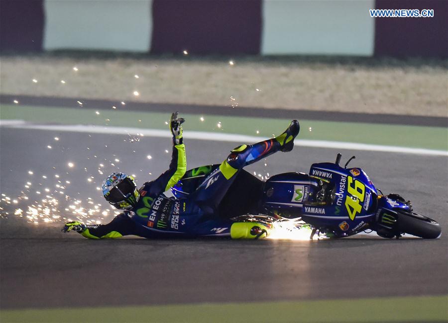 Italian rider Valentino Rossi of Movistar Yamaha MotoGP is thrown from his bike as he crashes out during the pre-season test at the Losail International Circuit in Qatar's capital Doha on March 11, 2017, ahead of Grand Prix of Qatar which will be held from March 23 to 26. 