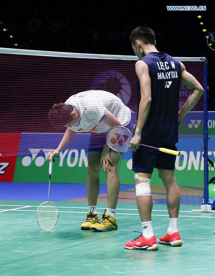 Shi Yuqi(L) of China is injured during the men's singles final with Lee Chong Wei of Malaysia at All England Open Badminton Championships 2017 in Birmingham, Britain on March 12, 2017.