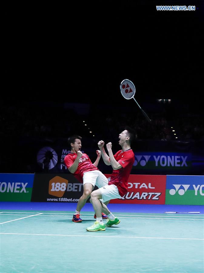 Marcus Fernaldi Gideon/Kevin Sanjaya Sukamuljo (R) of Indonesia celebrate victory during the men's doubles final with Li Junhui/Liu Yuchen of China at All England Open Badminton Championships 2017 in Birmingham, Britain on March 12, 2017. 
