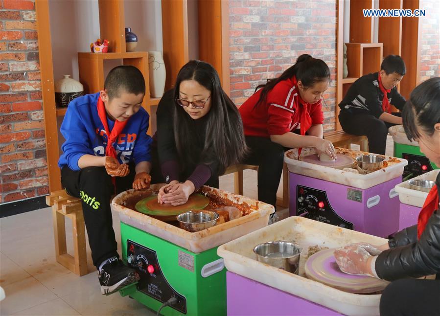 Pupils make pottery wares during a class at a primary school in Zhangjiakou City, north China's Hebei Province, March 13, 2017.