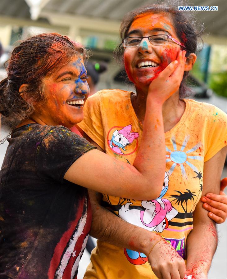 Girls of Indian community in Qatar throw colored powder on each other as they celebrate annual Holi, the Indian festival of Colors, in Doha, capital of Qatar, on March 13, 2017. 