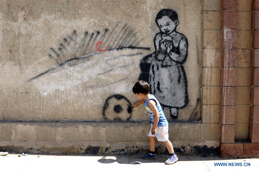 A boy paints graffiti on a wall during a campaign in Sanaa, Yemen, on March 15, 2017. A campaign was staged for people to express their wishes for peace and rejection of violence and war by painting graffiti on the walls of Sanaa's streets here on Wednesday. (Xinhua/Mohammed Mohammed) 