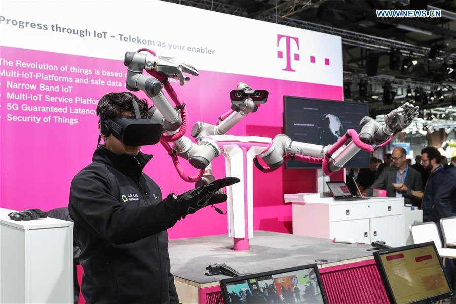 A staff member of Deutsche Telekom booth displays a robot controlled by VR devices during the Bosch ConnectedWorld 2017 in Berlin, capital of Germany, on March 15, 2017. 